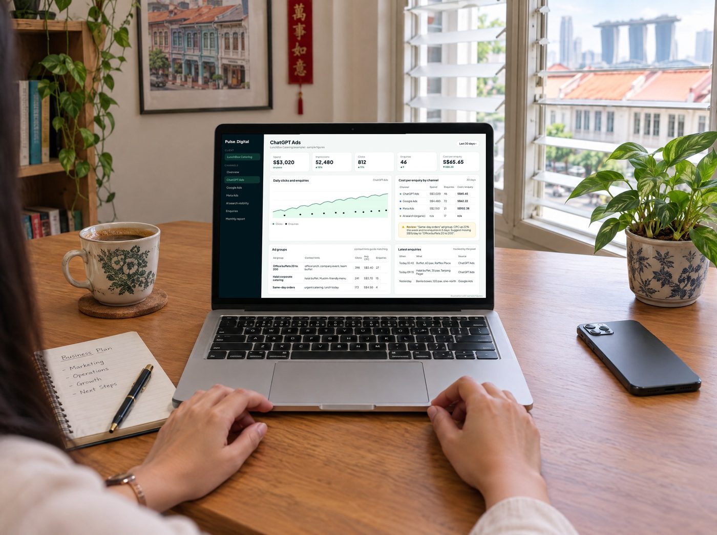 A laptop on a desk showing the PULSE Digital dashboard with ChatGPT Ads spend, clicks, enquiries and cost per enquiry next to Google Ads and Meta Ads